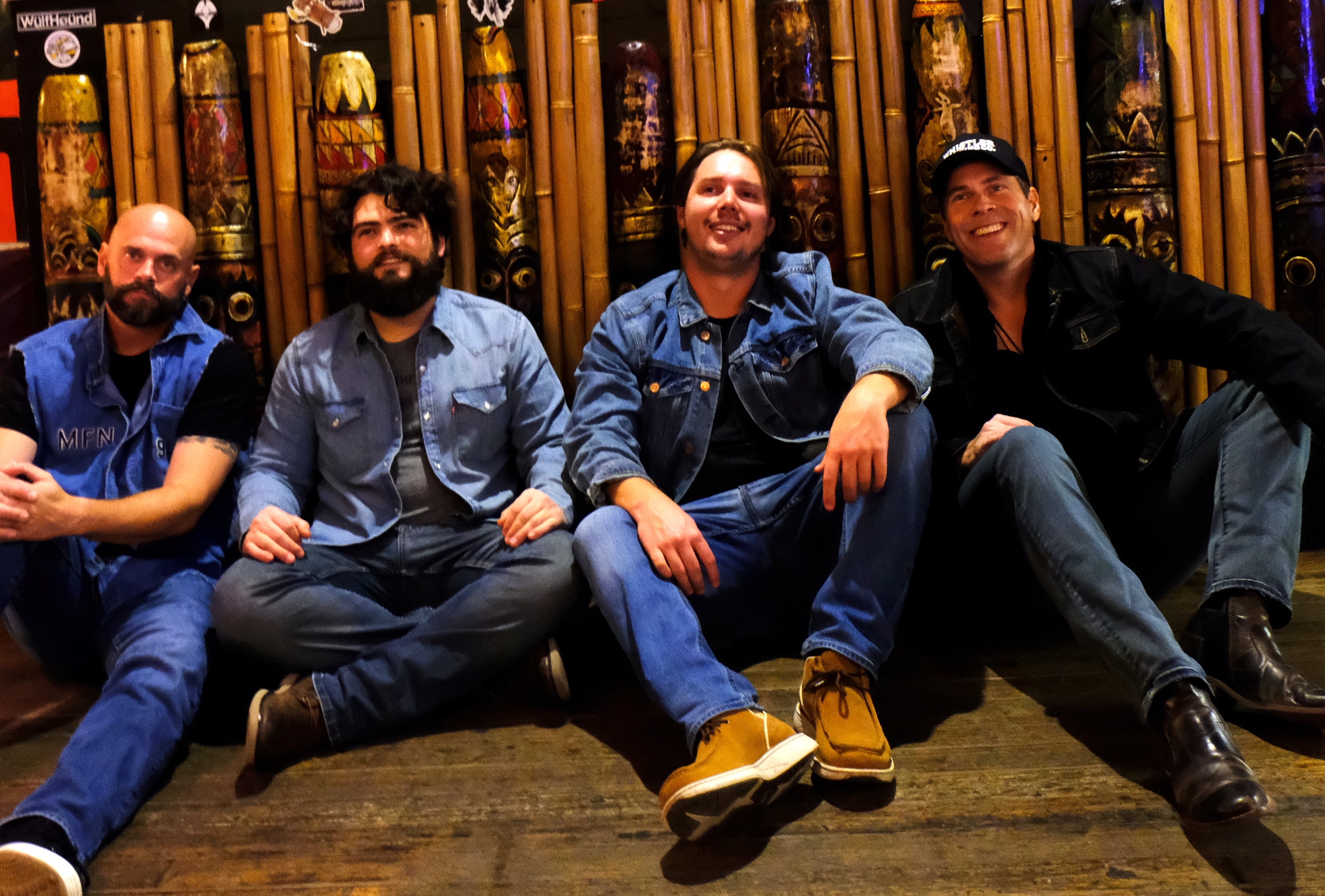 full band sitting on floor